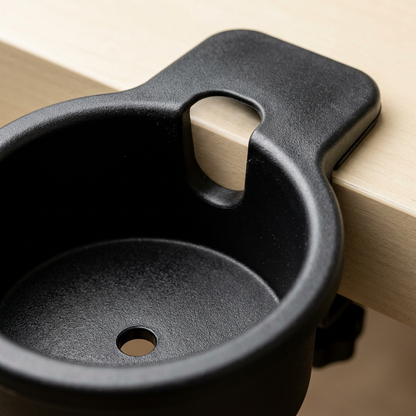 Macro close-up of the mug-handle slot and drain hole of a black desk cup holder