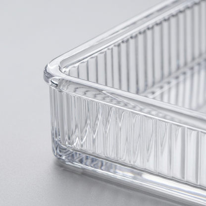 Macro close-up of the ribbed wall and rounded rim of a clear acrylic organizer bin